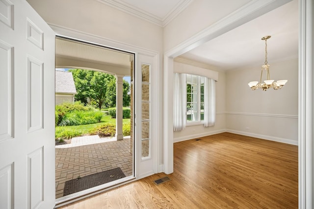 775 S Camelot Ct, Lake Forest, IL 60045 - entrance foyer featuring healthy amount of natural light, crown molding, a chandelier, and wood finished floors