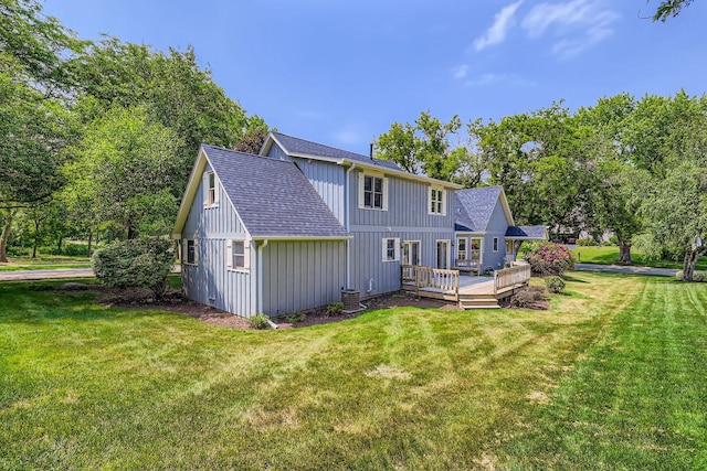 201 S Wulff St, Cary, IL 60013 - rear view of house with board and batten siding, a wooden deck, a shingled roof, and a lawn