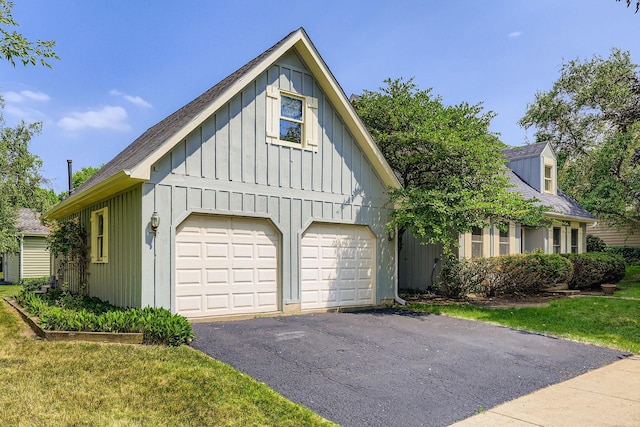201 S Wulff St, Cary, IL 60013 - view of front of home featuring board and batten siding, driveway, and a shingled roof