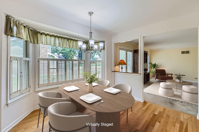 201 S Wulff St, Cary, IL 60013 - dining space with a chandelier and light wood-style flooring