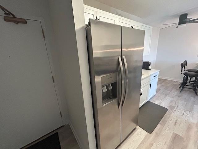 9098 Terrace Dr Unit 3E, Niles, IL 60714 - kitchen with stainless steel fridge, white cabinetry, light wood-style floors, a ceiling fan, and light countertops