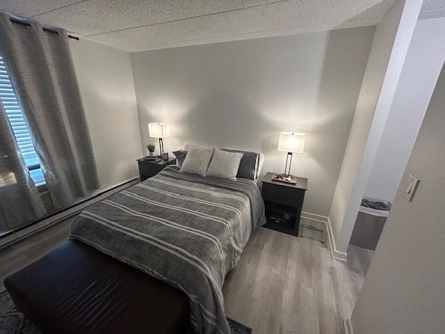 9098 Terrace Dr Unit 3E, Niles, IL 60714 - bedroom with wood finished floors and a textured ceiling