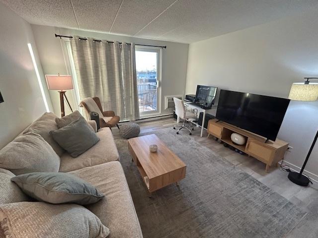 9098 Terrace Dr Unit 3E, Niles, IL 60714 - living room featuring wood finished floors and an office area