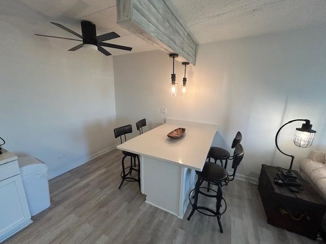 9098 Terrace Dr Unit 3E, Niles, IL 60714 - dining area featuring wood finished floors, ceiling fan, and a textured ceiling