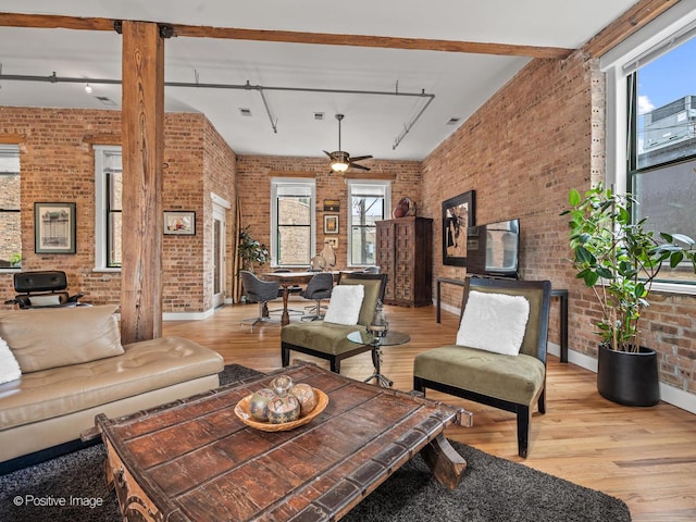 2035 W Charleston St Unit 205, Chicago, IL 60647 - living room with brick wall, rail lighting, healthy amount of natural light, and wood finished floors