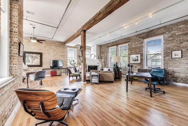2035 W Charleston St Unit 205, Chicago, IL 60647 - office area featuring brick wall, rail lighting, wood finished floors, a fireplace, and a ceiling fan