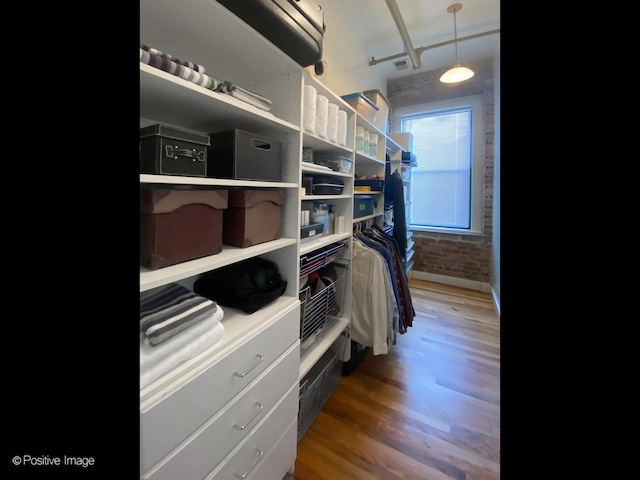 2035 W Charleston St Unit 205, Chicago, IL 60647 - walk in closet featuring wood finished floors