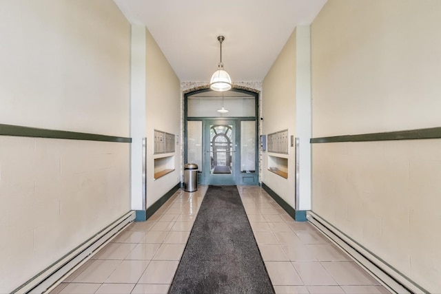 2035 W Charleston St Unit 205, Chicago, IL 60647 - entryway with a baseboard heating unit and light tile patterned floors