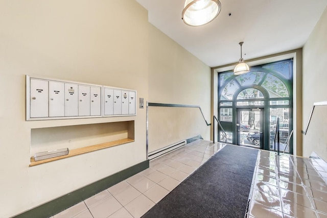 2035 W Charleston St Unit 205, Chicago, IL 60647 - foyer with mail area, tile patterned flooring, and a baseboard radiator