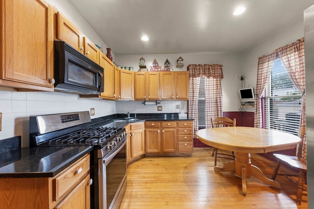 1318 S 61st Ct, Cicero, IL 60804 - kitchen with stainless steel range with gas stovetop, black microwave, light wood-style flooring, dark countertops, and recessed lighting