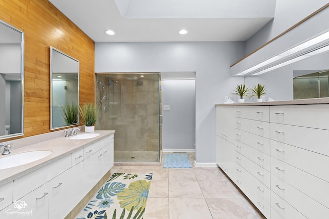 1886 N Springview Dr, Kankakee, IL 60901 - full bathroom with double vanity, wooden walls, a stall shower, tile patterned floors, and recessed lighting
