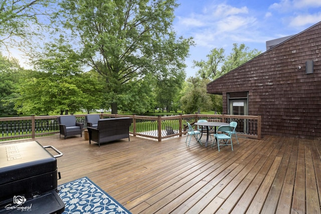 1886 N Springview Dr, Kankakee, IL 60901 - deck with outdoor dining area, an outdoor hangout area, and view of wooded area