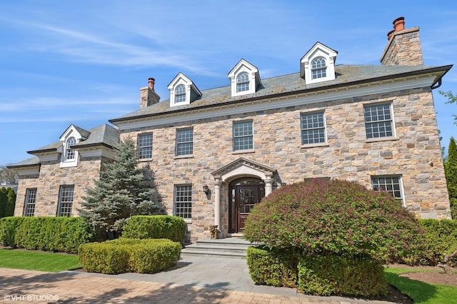 78 Wagner Rd, Northfield, IL 60093 - georgian-style home featuring a chimney, a high end roof, and stone siding