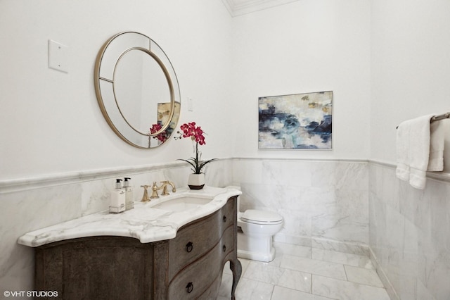 78 Wagner Rd, Northfield, IL 60093 - bathroom with marble finish floors, vanity, tile walls, a wainscoted wall, and ornamental molding