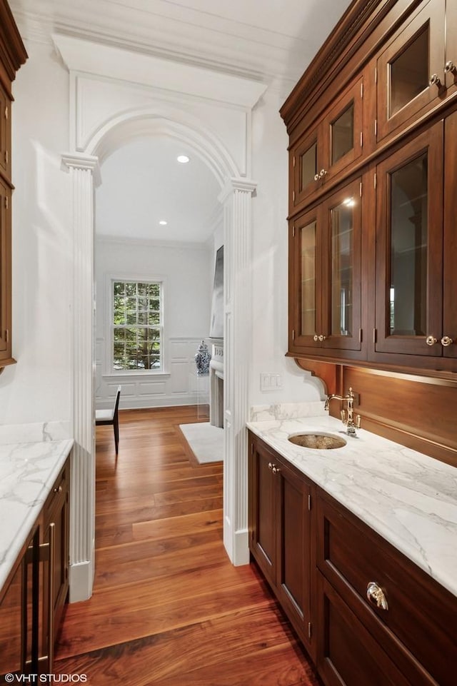 78 Wagner Rd, Northfield, IL 60093 - indoor wet bar with dark wood-style floors, a decorative wall, ornamental molding, recessed lighting, and arched walkways