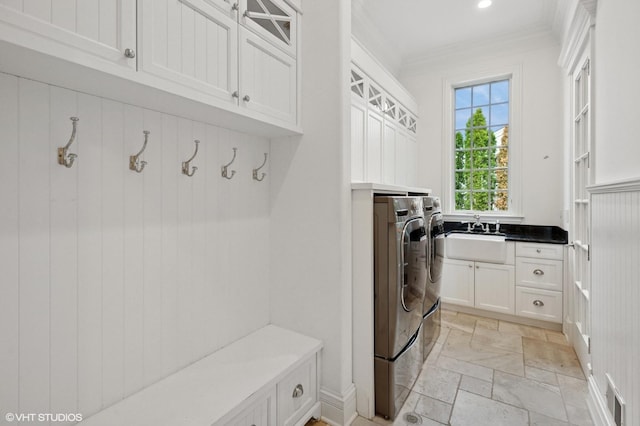 78 Wagner Rd, Northfield, IL 60093 - laundry room featuring separate washer and dryer, cabinet space, stone tile flooring, crown molding, and recessed lighting