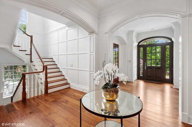 78 Wagner Rd, Northfield, IL 60093 - entryway with wood finished floors, stairway, a decorative wall, and ornate columns