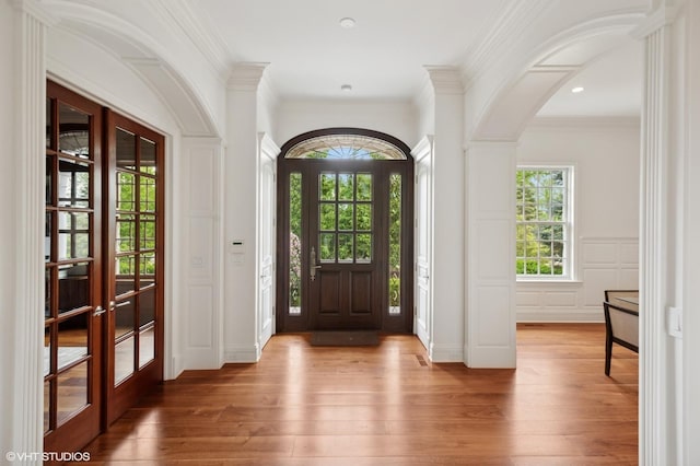 78 Wagner Rd, Northfield, IL 60093 - entryway featuring hardwood / wood-style floors, french doors, arched walkways, a decorative wall, and crown molding