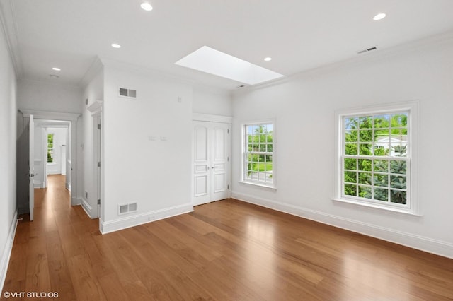 78 Wagner Rd, Northfield, IL 60093 - empty room featuring crown molding, a skylight, wood finished floors, and recessed lighting