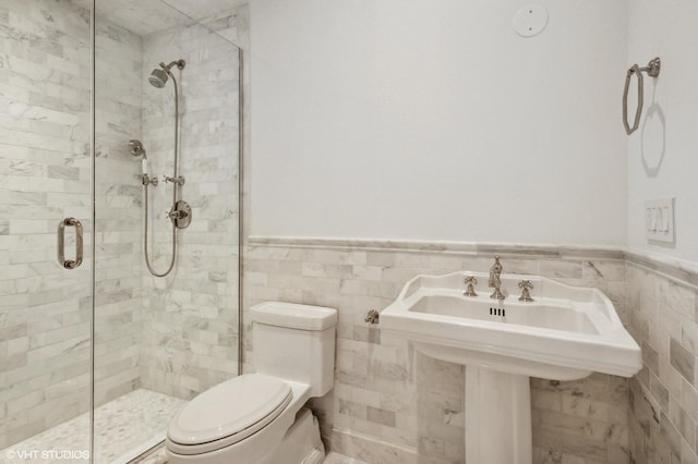 78 Wagner Rd, Northfield, IL 60093 - full bathroom with a shower stall, wainscoting, and tile walls