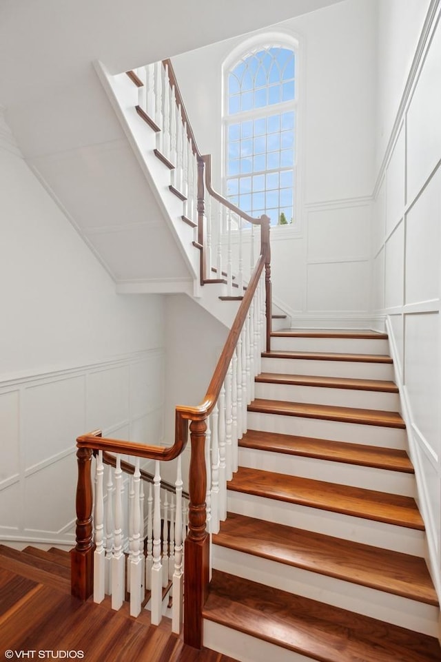 78 Wagner Rd, Northfield, IL 60093 - stairway featuring wood finished floors, a decorative wall, and a wainscoted wall