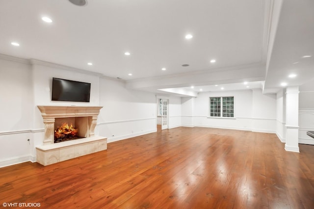 78 Wagner Rd, Northfield, IL 60093 - unfurnished living room featuring ornamental molding, a warm lit fireplace, wood-type flooring, and recessed lighting