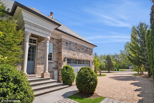 78 Wagner Rd, Northfield, IL 60093 - doorway to property featuring stone siding, a high end roof, and a garage