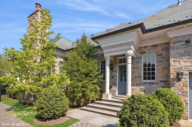 78 Wagner Rd, Northfield, IL 60093 - view of exterior entry featuring stone siding and a high end roof