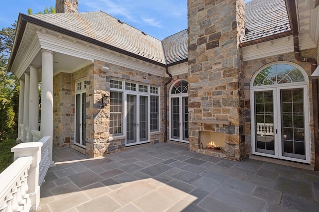 78 Wagner Rd, Northfield, IL 60093 - view of patio featuring french doors and an outdoor stone fireplace