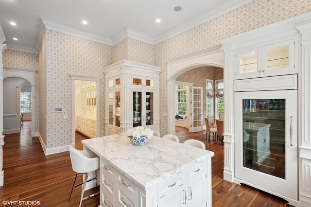 78 Wagner Rd, Northfield, IL 60093 - kitchen featuring arched walkways, crown molding, beverage cooler, dark wood-style floors, and glass insert cabinets