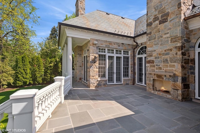 78 Wagner Rd, Northfield, IL 60093 - view of patio featuring french doors and an outdoor stone fireplace
