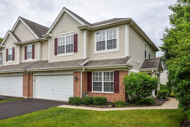 2131 Claremont Ln, Lake In The Hills, IL 60156 - townhome / multi-family property with brick siding, a front lawn, and asphalt driveway