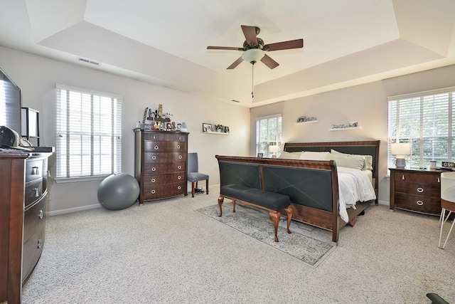 2131 Claremont Ln, Lake In The Hills, IL 60156 - bedroom with a tray ceiling, light carpet, and a ceiling fan