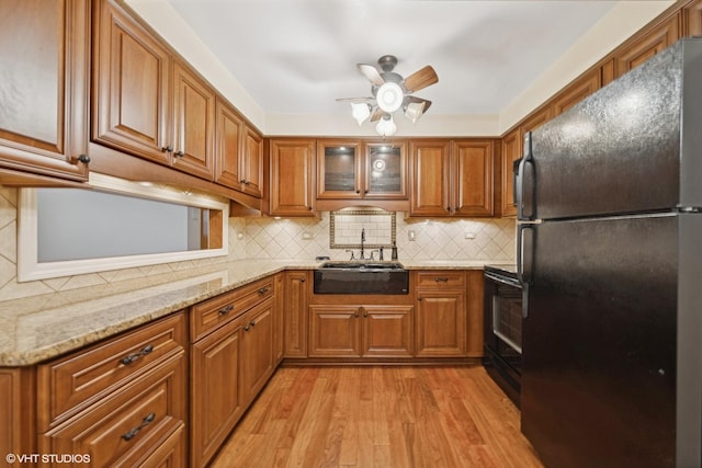 935 8th Ave Unit 1, La Grange, IL 60525 - kitchen featuring black appliances, brown cabinets, light wood finished floors, and ceiling fan