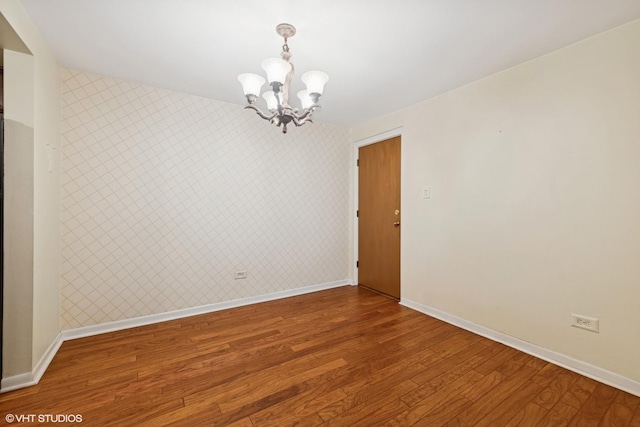 935 8th Ave Unit 1, La Grange, IL 60525 - empty room with a chandelier, wood finished floors, and wallpapered walls