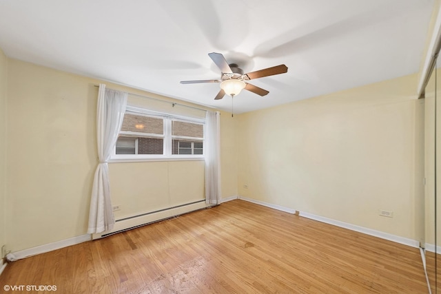 935 8th Ave Unit 1, La Grange, IL 60525 - spare room featuring ceiling fan, a baseboard radiator, and light wood-style flooring