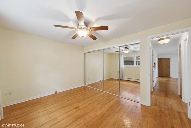 935 8th Ave Unit 1, La Grange, IL 60525 - unfurnished bedroom with light wood finished floors, baseboard heating, a closet, and a ceiling fan