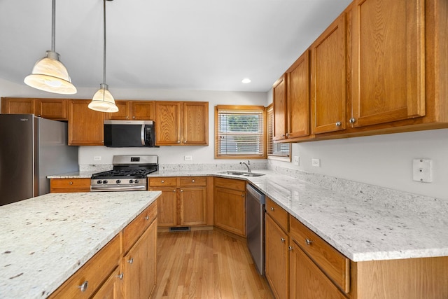 1301 Bridgehampton Dr, Plainfield, IL 60586 - kitchen featuring appliances with stainless steel finishes, light wood-type flooring, brown cabinetry, and recessed lighting