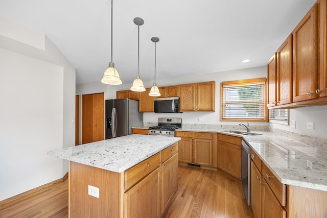 1301 Bridgehampton Dr, Plainfield, IL 60586 - kitchen featuring stainless steel appliances, light wood-style flooring, a kitchen island, light stone counters, and decorative light fixtures