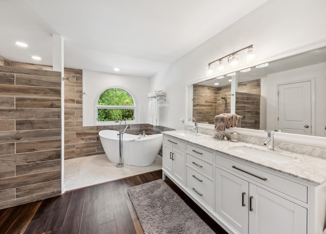 1551 Daybreak Dr, Libertyville, IL 60048 - full bath featuring tile walls, a walk in shower, double vanity, a freestanding bath, and wood finished floors