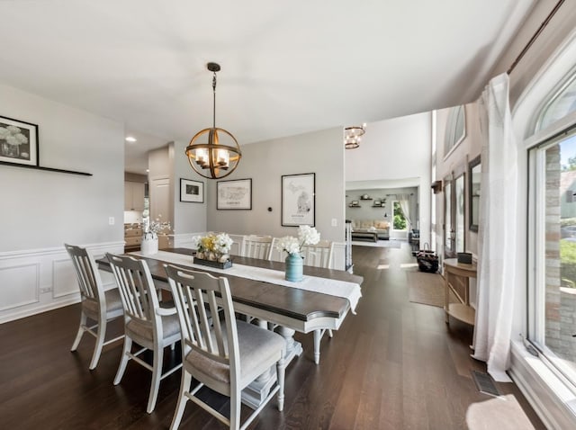 1551 Daybreak Dr, Libertyville, IL 60048 - dining space featuring a chandelier, healthy amount of natural light, dark wood-style floors, a wainscoted wall, and a decorative wall