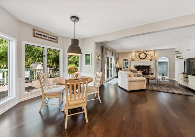 1551 Daybreak Dr, Libertyville, IL 60048 - dining space with dark wood-style floors and a brick fireplace