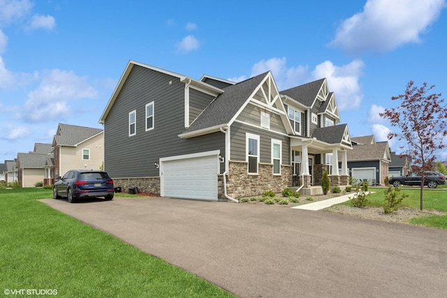 12906 S Sydney Cir, Plainfield, IL 60585 - view of property exterior with stone siding, an attached garage, asphalt driveway, a lawn, and a residential view