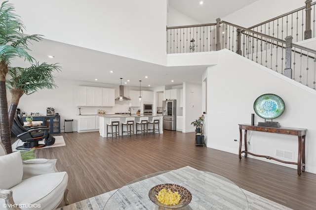 12906 S Sydney Cir, Plainfield, IL 60585 - living room featuring dark wood-style floors, a high ceiling, recessed lighting, and stairway
