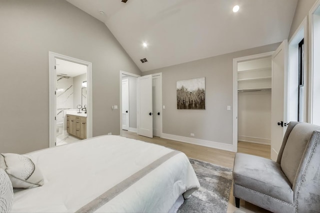 2902 N Seeley Ave, Chicago, IL 60618 - bedroom with lofted ceiling, light wood-style flooring, ensuite bath, a walk in closet, and recessed lighting