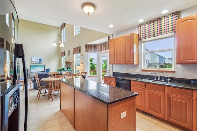 8610 Pebble Creek Ct, Wonder Lake, IL 60097 - kitchen with dishwasher, a kitchen island, dark stone countertops, light tile patterned floors, and recessed lighting