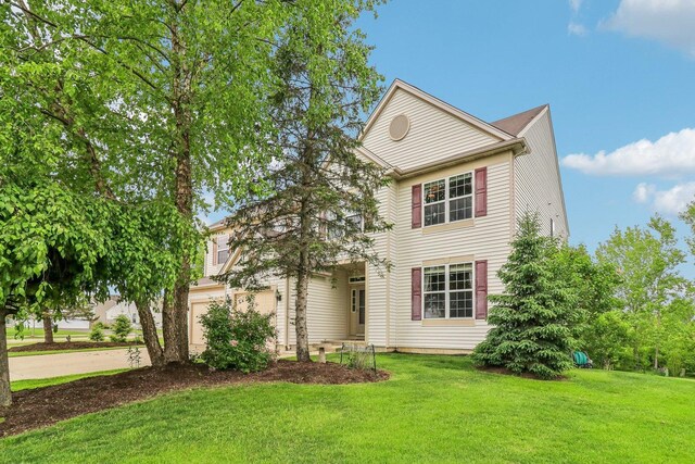 8610 Pebble Creek Ct, Wonder Lake, IL 60097 - view of front of home with a front lawn, concrete driveway, and a garage