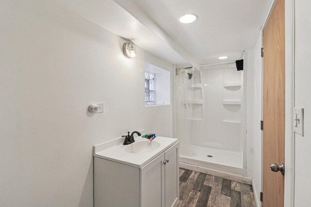 7659 S Rhodes Ave, Chicago, IL 60619 - bathroom featuring wood finished floors, a stall shower, and vanity