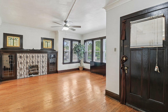 7659 S Rhodes Ave, Chicago, IL 60619 - foyer entrance featuring a ceiling fan, a fireplace, wood finished floors, and ornamental molding