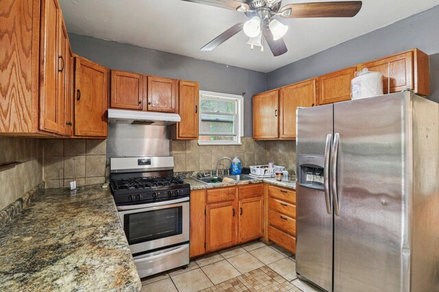 7659 S Rhodes Ave, Chicago, IL 60619 - kitchen with stainless steel appliances, under cabinet range hood, ceiling fan, backsplash, and light tile patterned flooring
